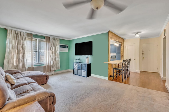 living room featuring light carpet, baseboards, a wall unit AC, and ornamental molding