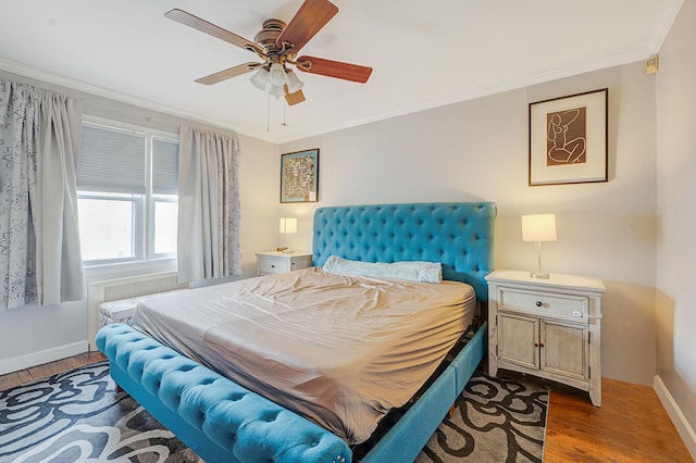 bedroom with baseboards, dark wood finished floors, a ceiling fan, and crown molding