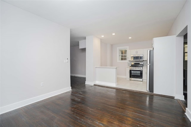 unfurnished living room featuring hardwood / wood-style floors