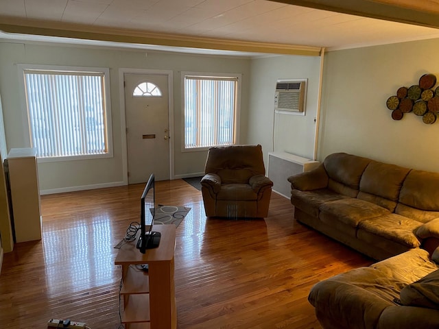 living room featuring crown molding, an AC wall unit, and hardwood / wood-style floors