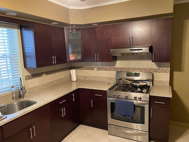 kitchen with light tile patterned floors, stainless steel range with gas stovetop, backsplash, ornamental molding, and sink