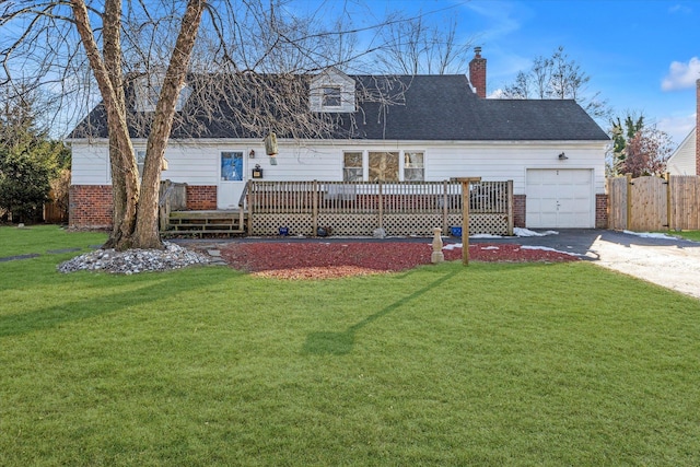 view of front of property featuring driveway, a wooden deck, a front lawn, and brick siding