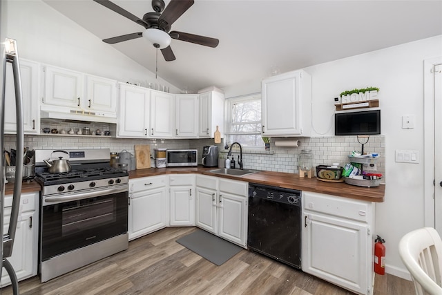 kitchen with white cabinets, stainless steel appliances, and butcher block countertops