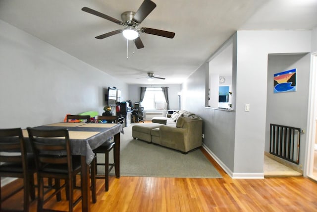 dining area featuring baseboards and wood finished floors