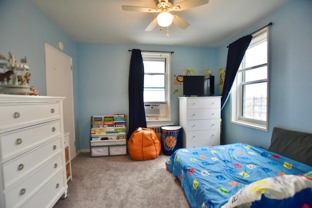 bedroom featuring a ceiling fan, cooling unit, and light colored carpet