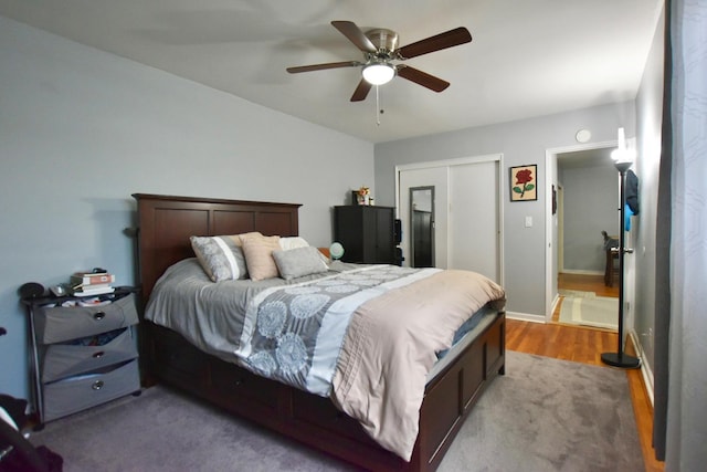 bedroom featuring baseboards, a closet, light wood-style flooring, and a ceiling fan