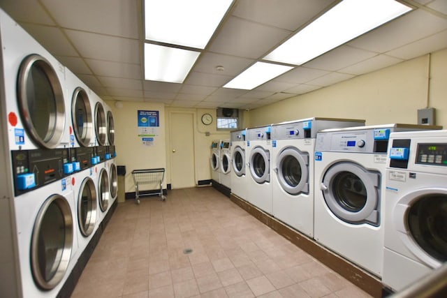 common laundry area with stacked washer / dryer and washing machine and clothes dryer