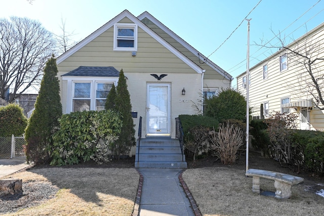 view of front of house with entry steps and fence