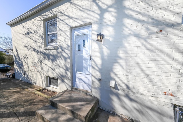 doorway to property with brick siding