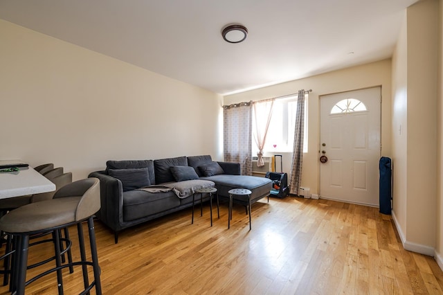 living room featuring baseboard heating and light wood-type flooring