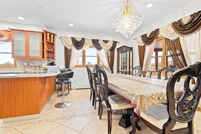 dining space with a chandelier, recessed lighting, and baseboard heating