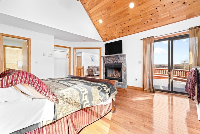 bedroom with high vaulted ceiling, a fireplace, wood finished floors, wood ceiling, and access to exterior