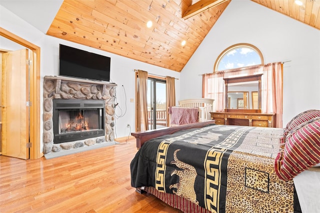 bedroom with access to outside, multiple windows, wooden ceiling, and wood finished floors