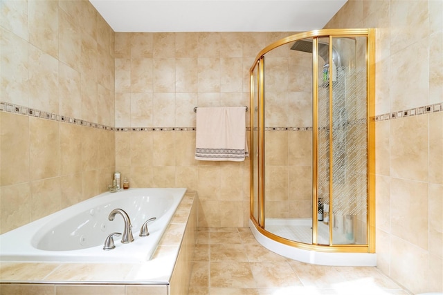 bathroom with a stall shower, tile walls, and a bath