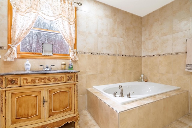 bathroom with a garden tub, tile patterned floors, tile walls, and vanity