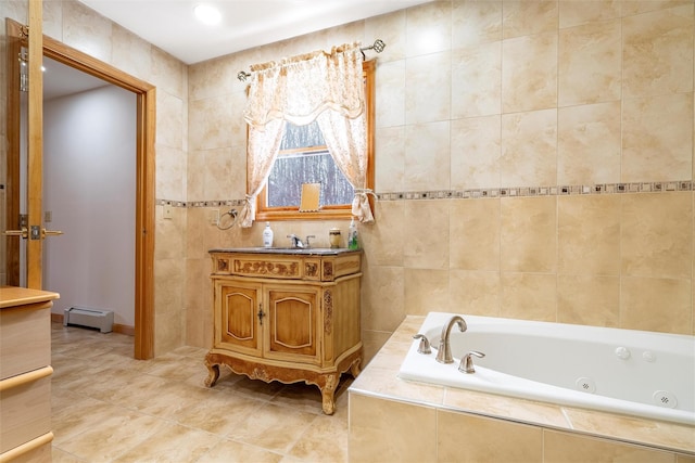 full bath featuring a baseboard heating unit, vanity, tile walls, tile patterned floors, and a whirlpool tub