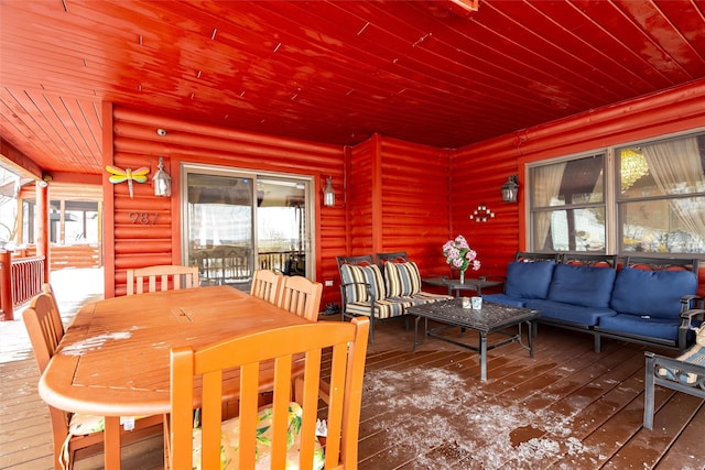 dining area featuring wood ceiling, log walls, and wood finished floors