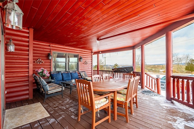 wooden deck featuring outdoor dining area and an outdoor hangout area