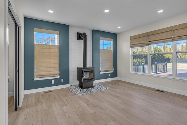 unfurnished living room with baseboards, light wood finished floors, visible vents, and recessed lighting