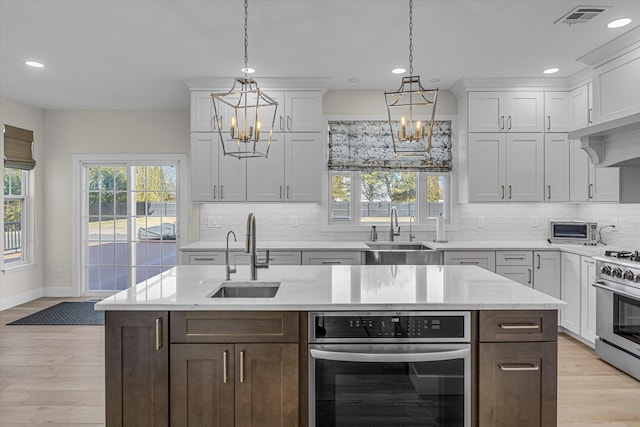 kitchen featuring white cabinetry and a sink