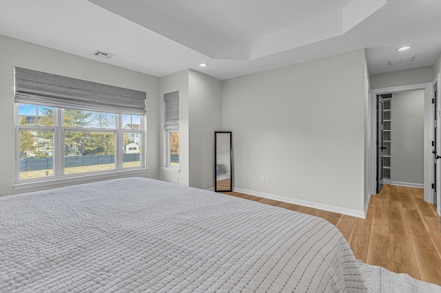 bedroom featuring light wood-style flooring, baseboards, recessed lighting, and visible vents