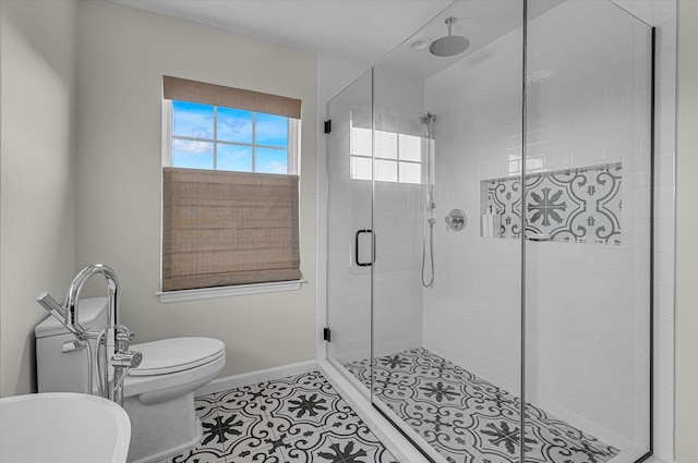 bathroom featuring baseboards, tile patterned floors, toilet, and a stall shower