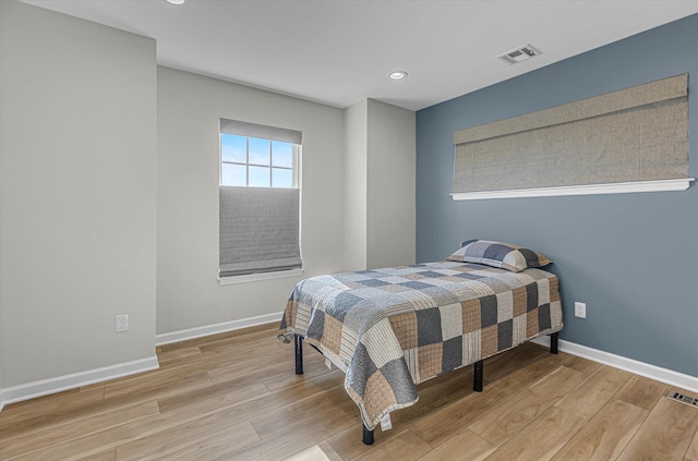 bedroom with baseboards, recessed lighting, visible vents, and light wood-style floors