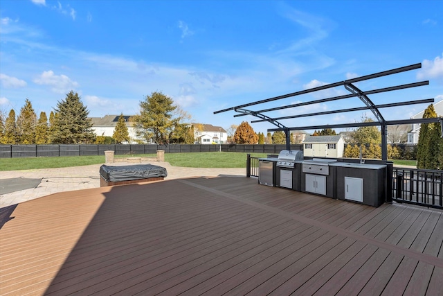 deck with a sink, area for grilling, a hot tub, a fenced backyard, and a pergola