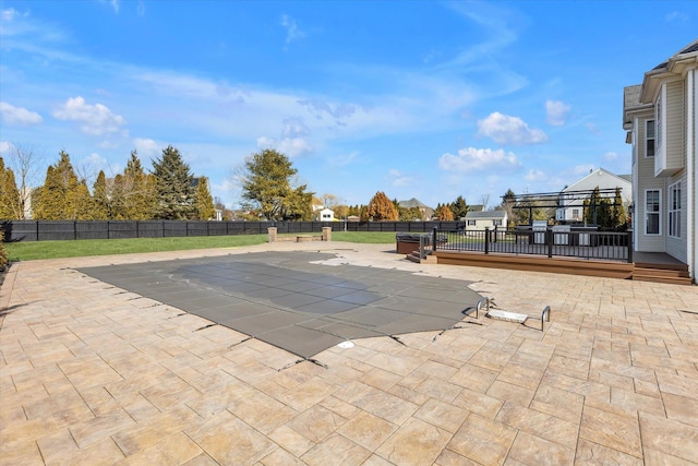 view of swimming pool with a patio area, a yard, and a fenced backyard