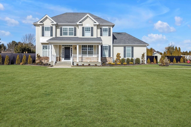 view of front of property with fence, a front lawn, a shingled roof, and covered porch