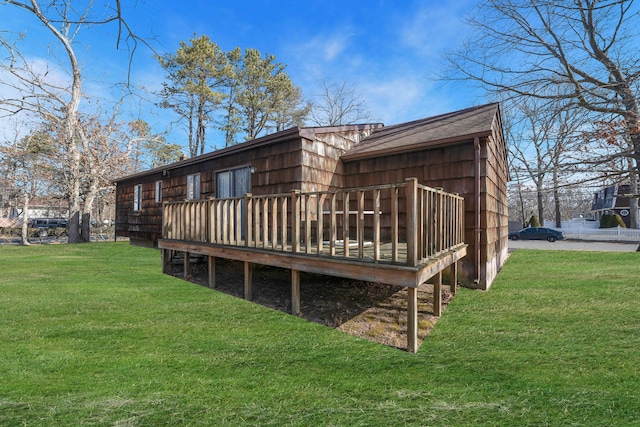 rear view of house featuring a yard and a wooden deck