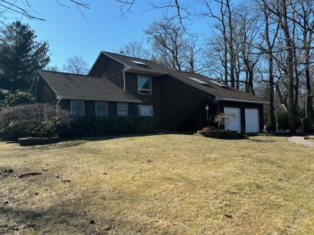 view of front of house with a garage and a front yard