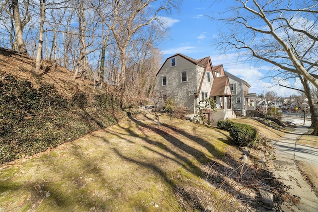 view of property exterior featuring a lawn