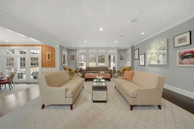 living room with ornamental molding, wood finished floors, recessed lighting, french doors, and decorative columns