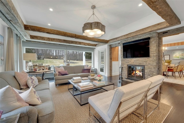 living room with beam ceiling, recessed lighting, a fireplace, and wood-type flooring