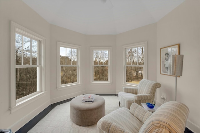 living area featuring baseboards