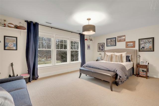 carpeted bedroom featuring baseboards and visible vents