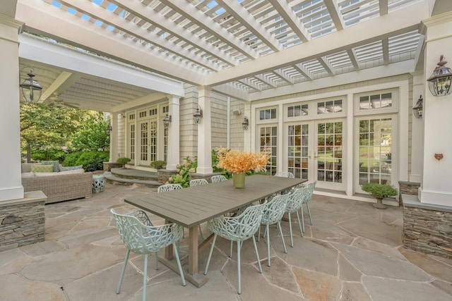 view of patio with outdoor dining space, french doors, and a pergola