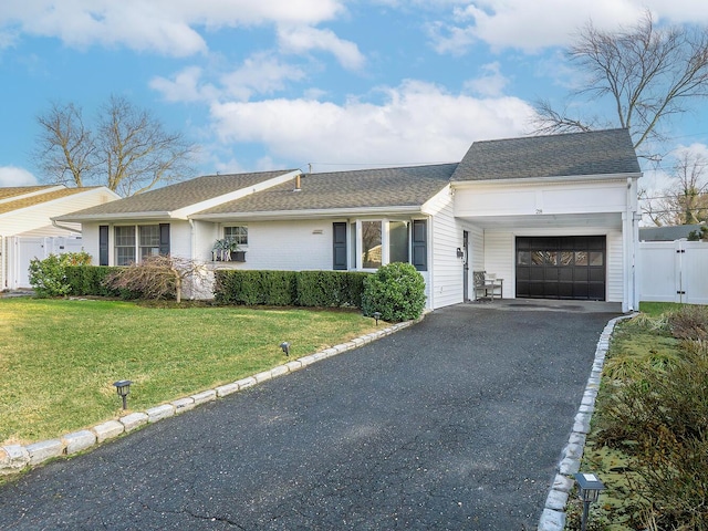 single story home featuring a front yard and a garage