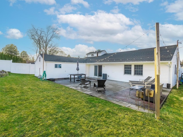 rear view of house featuring a patio and a yard