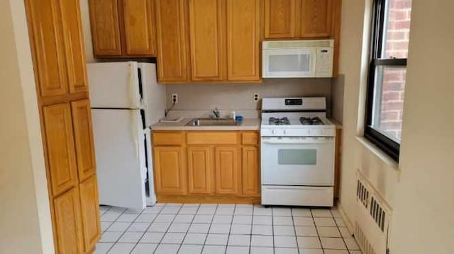 kitchen with light tile patterned flooring, white appliances, a sink, visible vents, and light countertops