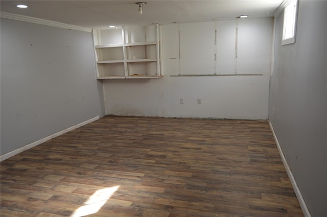 basement featuring crown molding and dark wood-type flooring