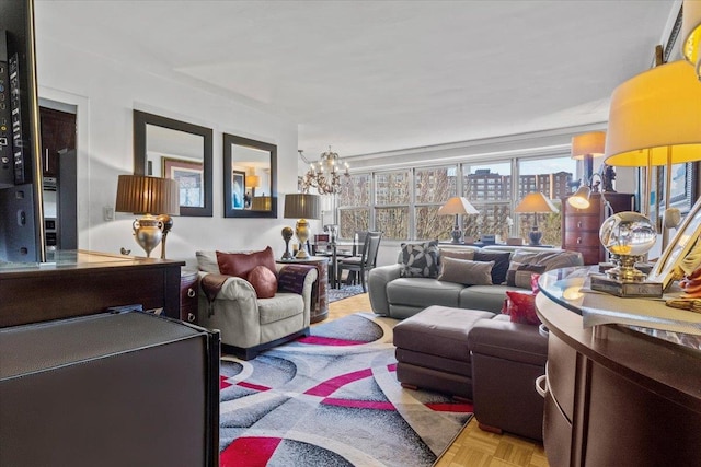 living room featuring an inviting chandelier and light parquet flooring