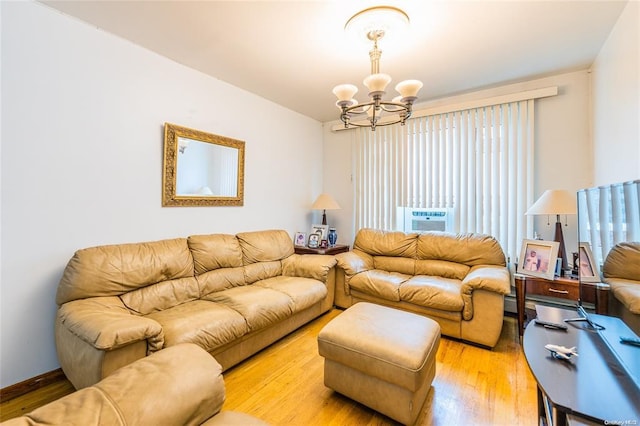 living room featuring a notable chandelier, light wood-type flooring, and cooling unit