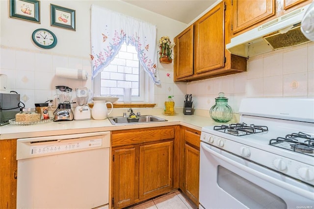 kitchen featuring sink, white appliances, tasteful backsplash, and light tile patterned floors