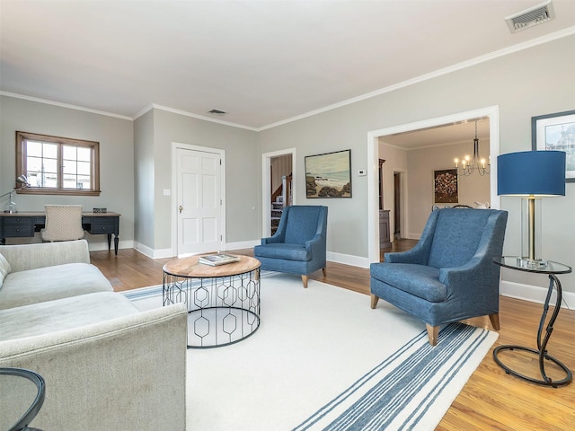 living room featuring baseboards, visible vents, a chandelier, and wood finished floors