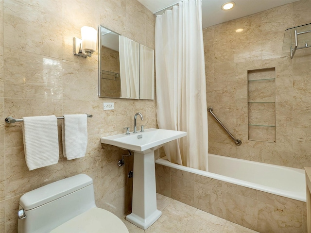 full bath featuring toilet, tiled shower / bath combo, tile walls, and tile patterned floors