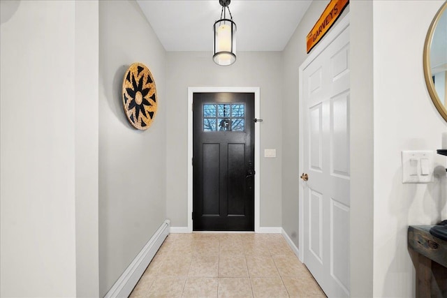 entrance foyer with a baseboard radiator, baseboards, and light tile patterned flooring