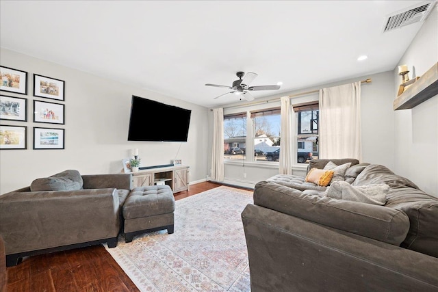 living area featuring baseboards, visible vents, a ceiling fan, dark wood-style flooring, and recessed lighting