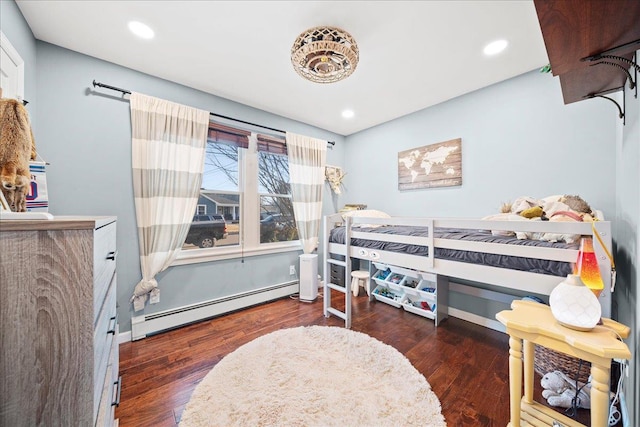 bedroom with baseboards, baseboard heating, wood finished floors, and recessed lighting